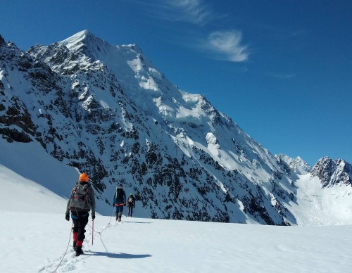 climbers walking on snowy glacier
