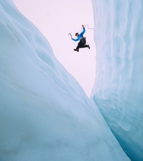 climber jumps over crevasse